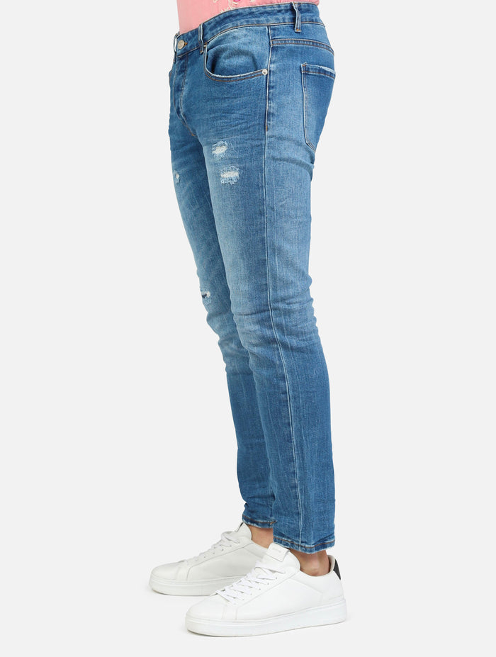 art. 1025: jeans con strappi, abrasioni e tasche taglio vivo